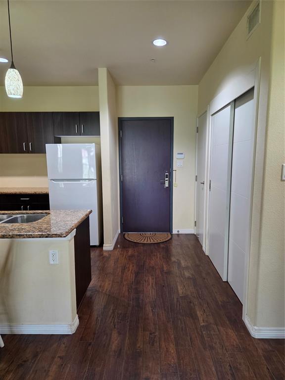 1100 West Trinity Mills Road, Unit 2014 Carrollton, TX 75006 - Photo 5 of 13 a kitchen with stainless steel appliances granite countertop a stove and a refrigerator