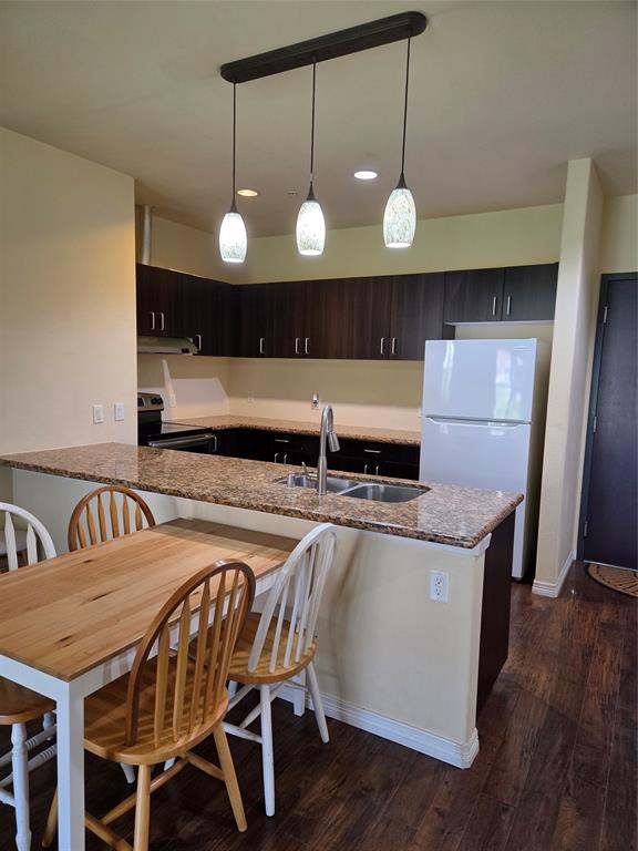 1100 West Trinity Mills Road, Unit 2014 Carrollton, TX 75006 - Photo 6 of 13 a view of a kitchen with a table and chairs