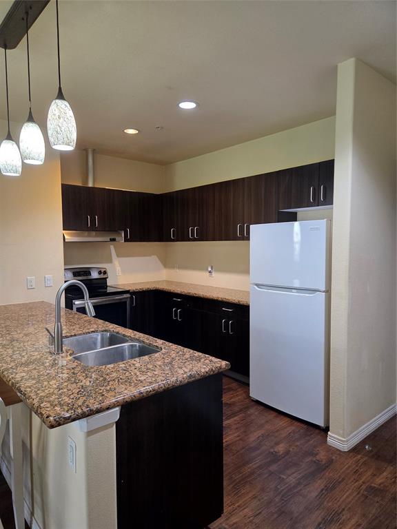 1100 West Trinity Mills Road, Unit 2014 Carrollton, TX 75006 - Photo 7 of 13 a kitchen with cabinets and stainless steel appliances