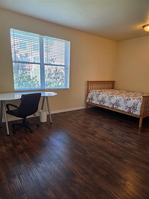1100 West Trinity Mills Road, Unit 2014 Carrollton, TX 75006 - Photo 8 of 13 a living room with furniture and a wooden floor