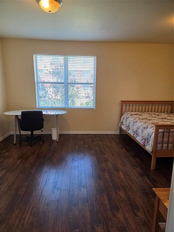1100 West Trinity Mills Road, Unit 2014 Carrollton, TX 75006 - Photo 9 of 13 a living room with furniture and a wooden floor