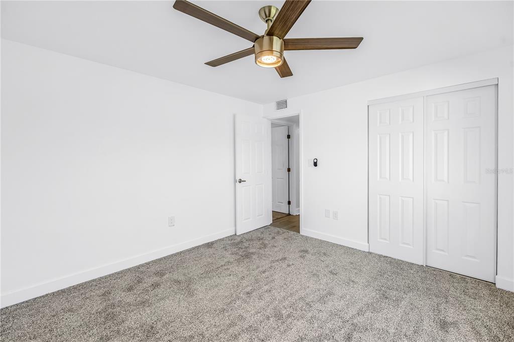 8630 Blind Pass Road, Unit 12 St. Pete Beach, FL 33706 - Photo 21 of 30 an empty room with a ceiling fan and a window