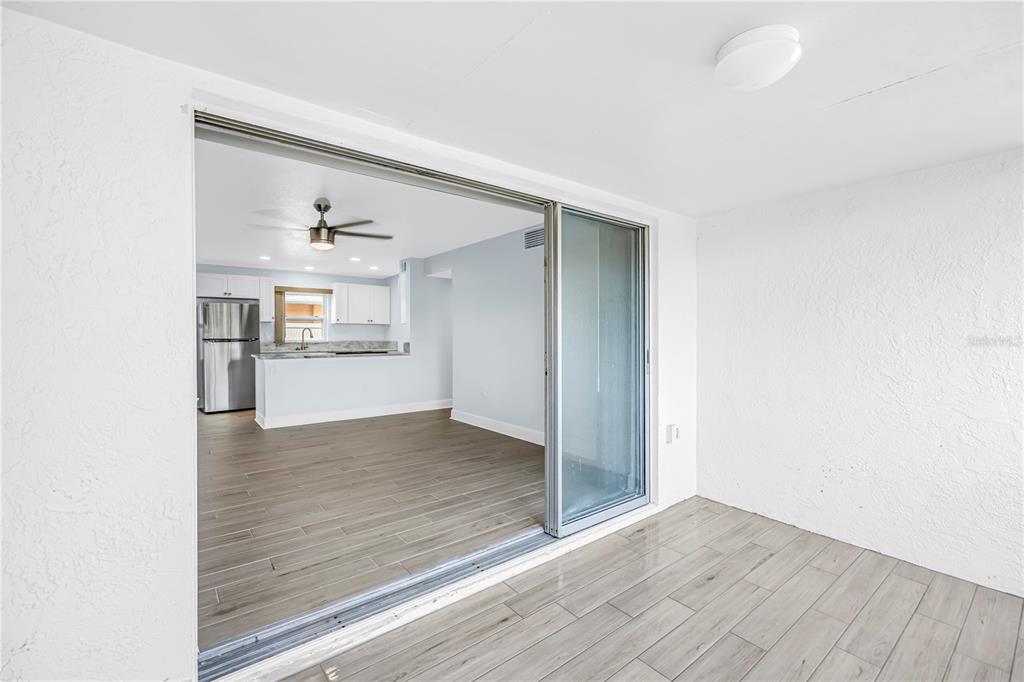 8630 Blind Pass Road, Unit 12 St. Pete Beach, FL 33706 - Photo 24 of 30 a view of a kitchen cabinets and wooden floor