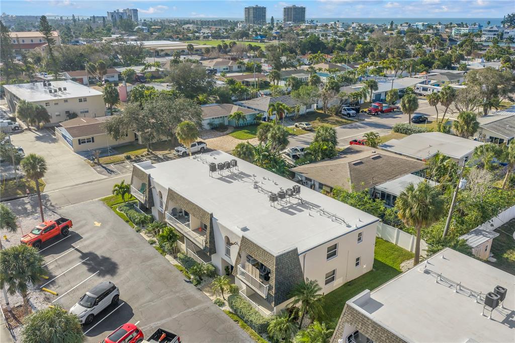 8630 Blind Pass Road, Unit 12 St. Pete Beach, FL 33706 - Photo 28 of 30 an aerial view of a house with a yard garage and lake view