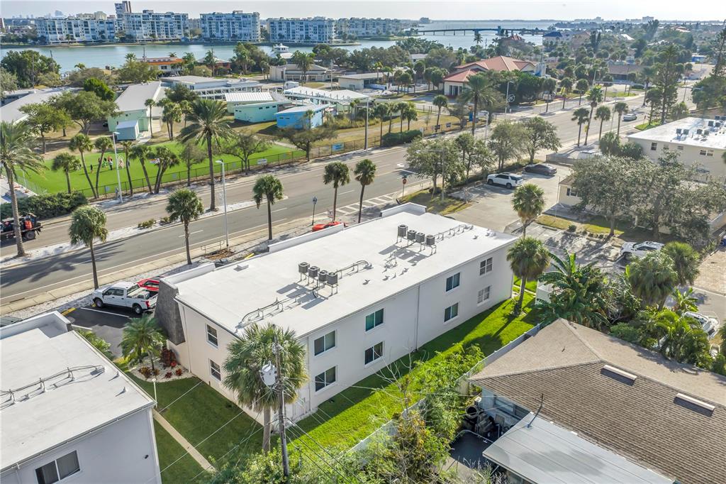 8630 Blind Pass Road, Unit 12 St. Pete Beach, FL 33706 - Photo 29 of 30 an aerial view of a house with a yard and lake view