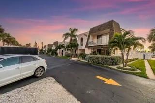 8630 Blind Pass Road, Unit 12 St. Pete Beach, FL 33706 - Photo 4 of 30 a view of a car parked in front of a house