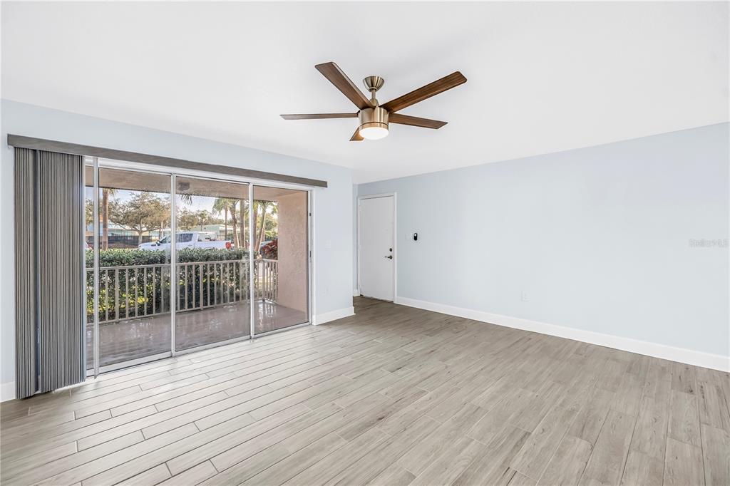 8630 Blind Pass Road, Unit 12 St. Pete Beach, FL 33706 - Photo 8 of 30 an empty room with wooden floor and windows