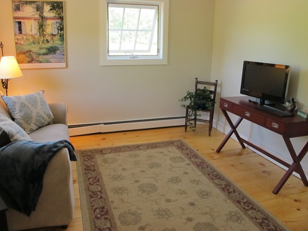 1 Juggler Meadow Road Leverett, MA 01054 - Photo 3 of 23 a living room with a couch and a flat screen tv
