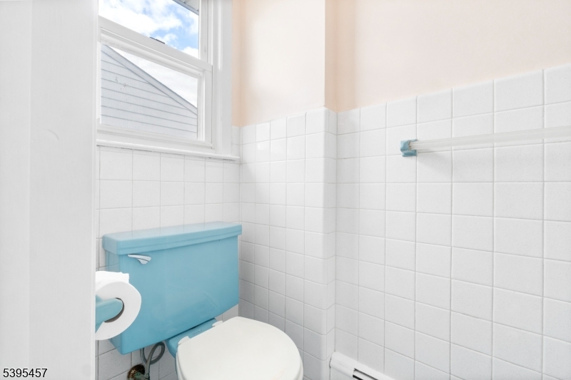 726 Gates Terrace Union, NJ 07083 - Photo 12 of 16 a white toilet sitting next to a bathroom sink