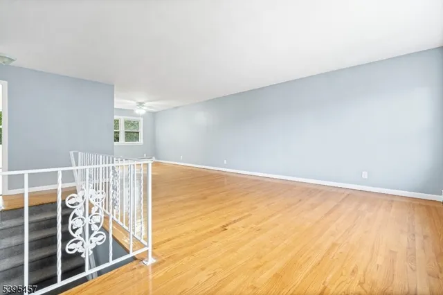 a view of a room with wooden floor