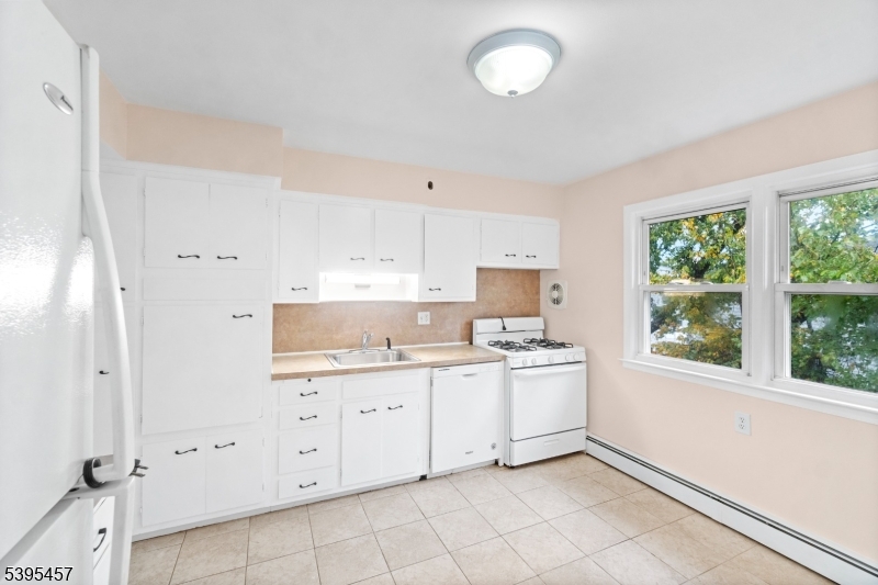 726 Gates Terrace Union, NJ 07083 - Photo 4 of 16 a room with a stove a sink and a window