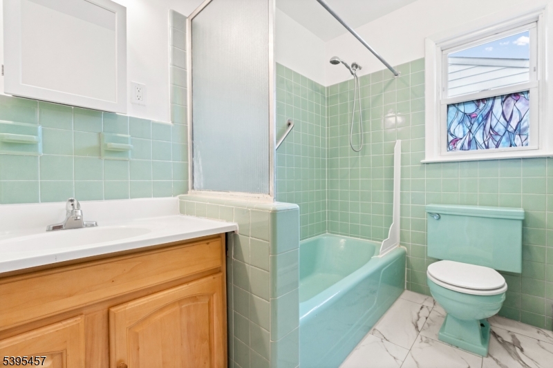 726 Gates Terrace Union, NJ 07083 - Photo 10 of 16 a bathroom with a sink a toilet and shower