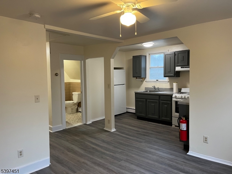 a kitchen with stainless steel appliances granite countertop a sink cabinets and wooden floor
