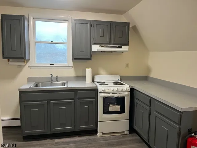 a kitchen with a sink and a stove top oven