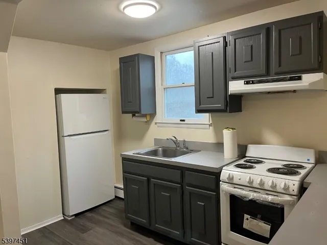 a kitchen with stainless steel appliances granite countertop a stove a refrigerator and a sink