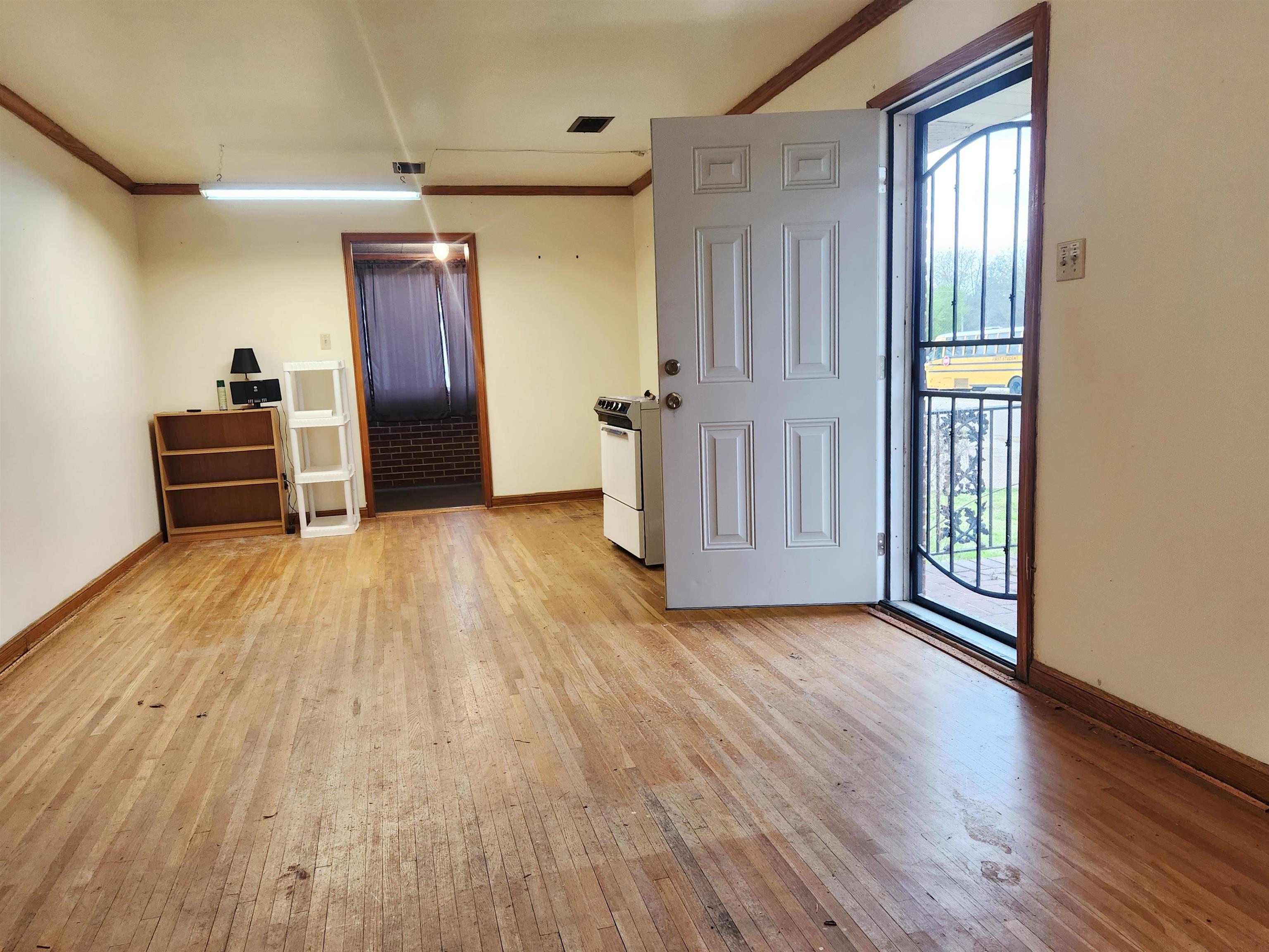 1452 South Perkins Road Memphis, TN 38117 - Photo 12 of 22 a view of empty room with wooden floor and fan
