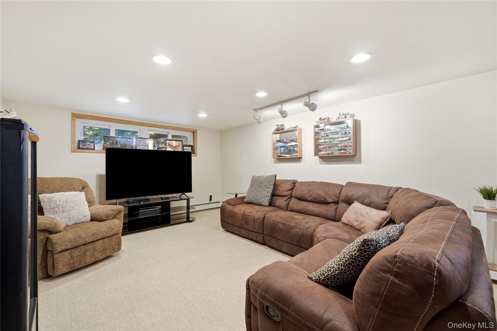 1853 Decatur Avenue Merrick, NY 11566 - Photo 30 of 43 a living room with furniture and a flat screen tv