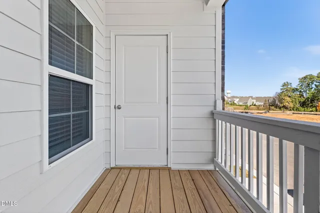 a view of balcony with wooden floor