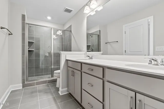 a bathroom with double sink and a mirror
