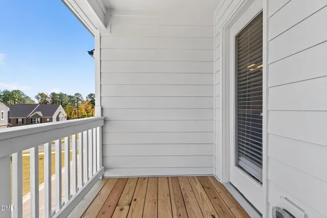a view of a balcony with wooden floor