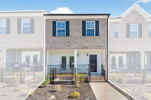 a view of a brick house with a outdoor space