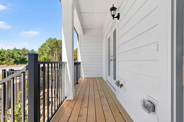 a view of balcony with wooden floor and fence