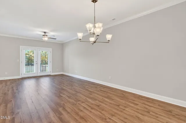 a view of a room with wooden floor and chandelier