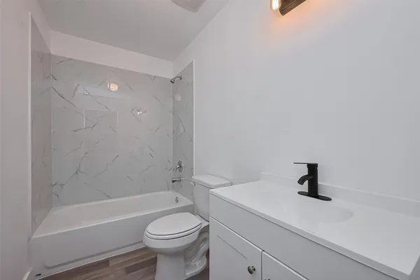 a bathroom with a sink a toilet and a bathtub