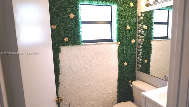 a bathroom with a toilet shower and window