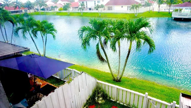a view of a backyard with a small deck and a garden