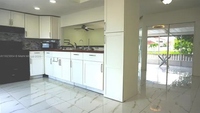 a spacious bathroom with a granite countertop sink a mirror and a shower