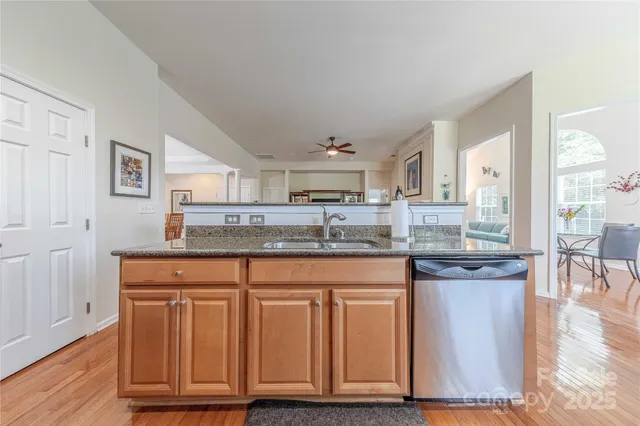 a kitchen with granite countertop a stove and cabinets