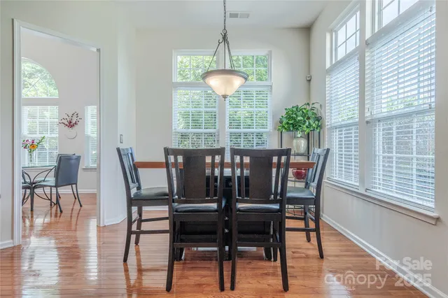 a view of a dining room with furniture window and wooden floor