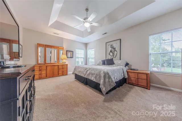 a bedroom with a large bed and a chandelier