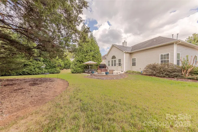 a view of a house with backyard and sitting area