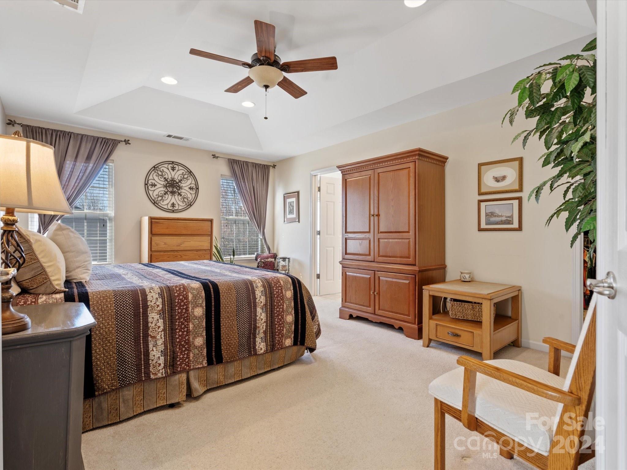 219 Clear Spring Court Fort Mill, SC 29708 - Photo 19 of 38 a bedroom with a bed and a chandelier