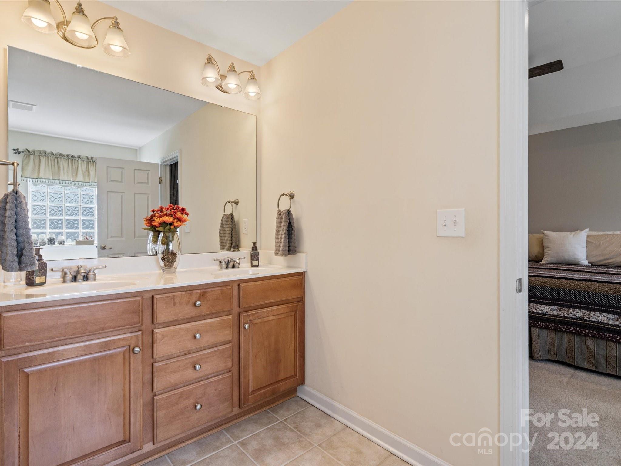 219 Clear Spring Court Fort Mill, SC 29708 - Photo 23 of 38 a spacious bathroom with a double vanity sink and a mirror