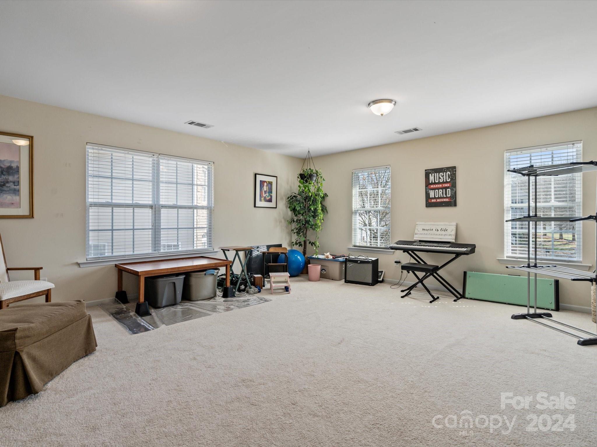 219 Clear Spring Court Fort Mill, SC 29708 - Photo 26 of 38 a living room with furniture a window and a flat screen tv