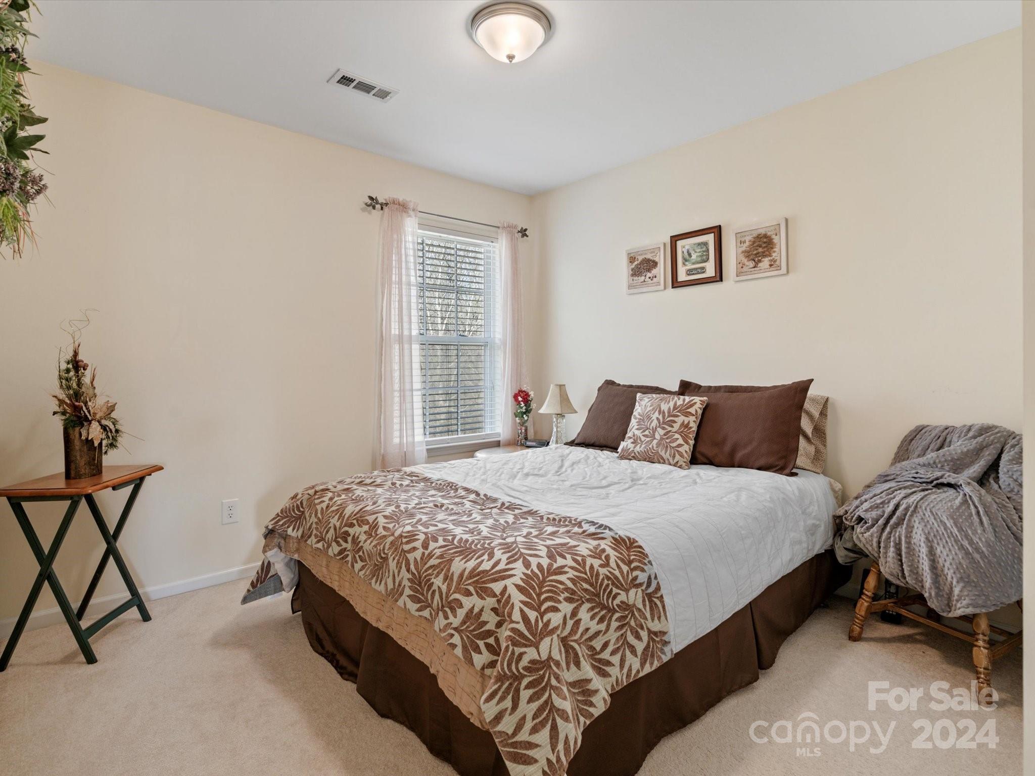219 Clear Spring Court Fort Mill, SC 29708 - Photo 27 of 38 a bedroom with bed and a window
