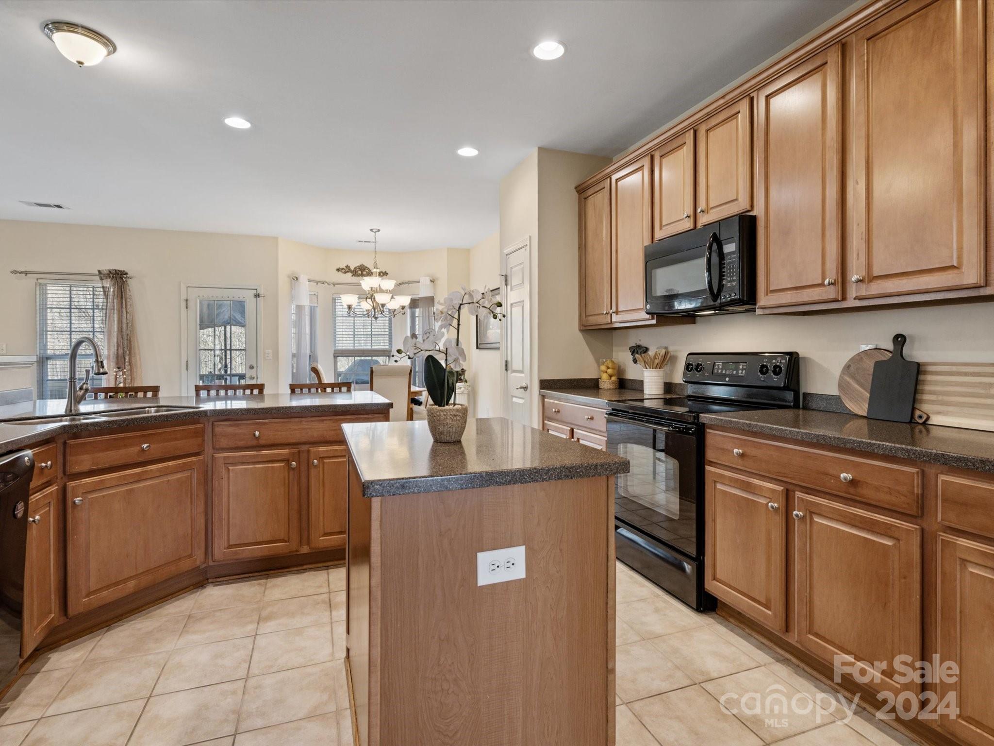 219 Clear Spring Court Fort Mill, SC 29708 - Photo 9 of 38 a kitchen with stainless steel appliances granite countertop a refrigerator stove microwave and sink