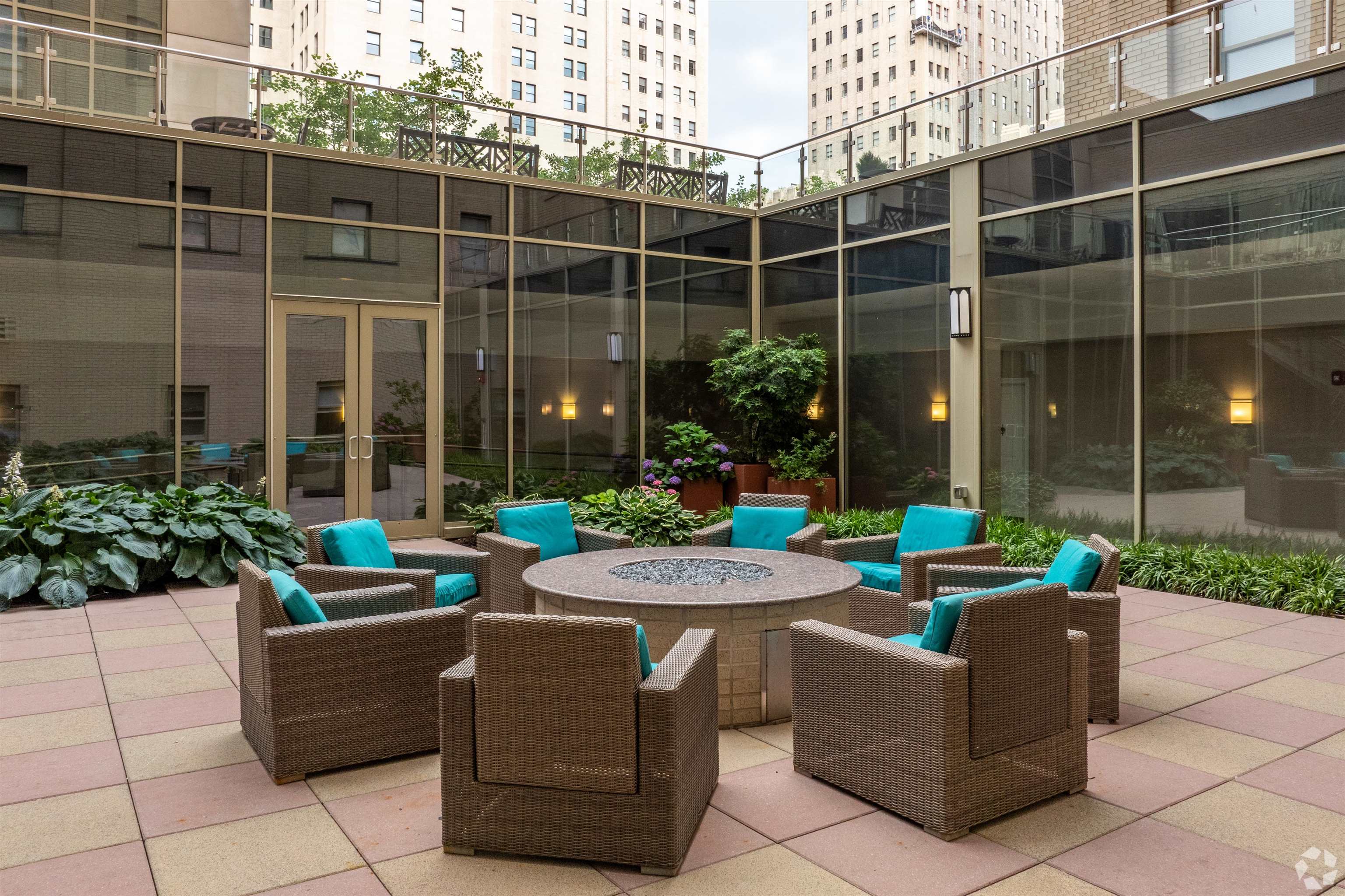 20 Beacon Way, Unit T1106 Jersey City, NJ 07304 - Photo 16 of 21 a view of a patio with couches and potted plants