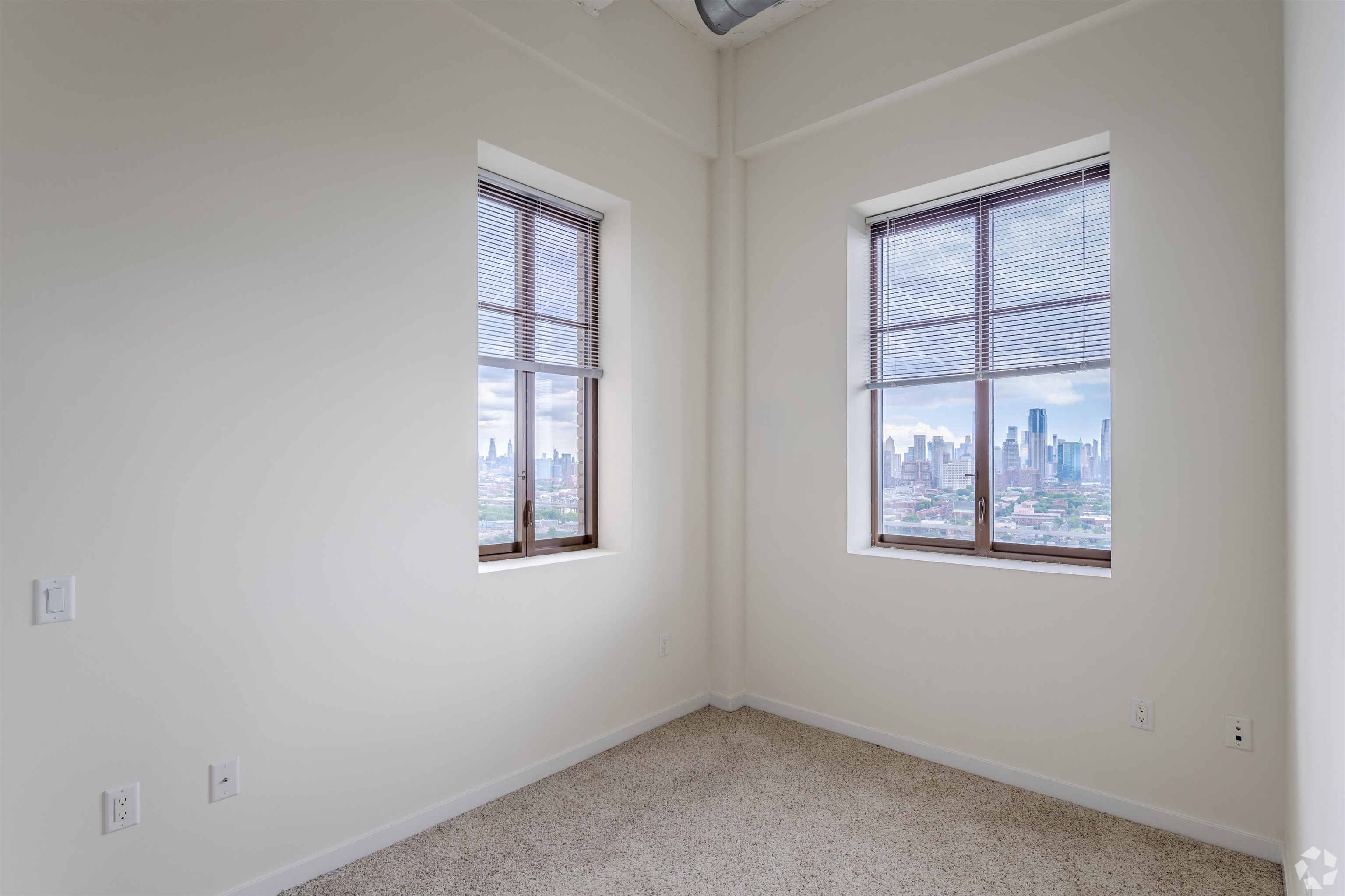 20 Beacon Way, Unit T1106 Jersey City, NJ 07304 - Photo 5 of 21 an empty room with windows and closet