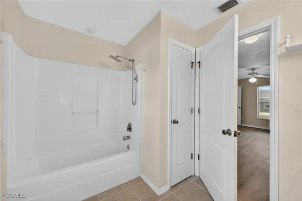 a bathroom with a bathtub and shower