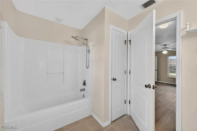 a bathroom with a bathtub and shower