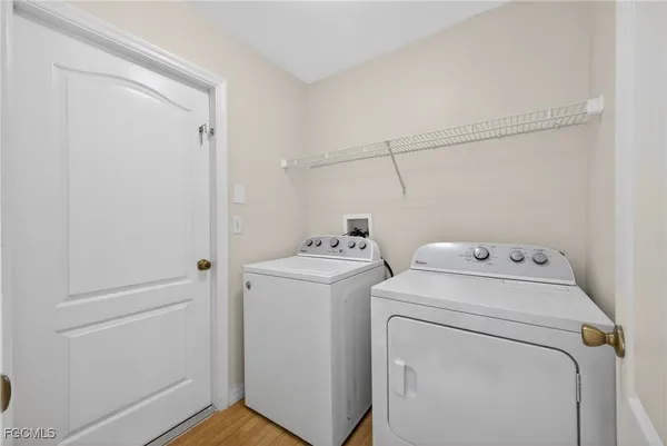 a view of storage and utility room with washer and dryer