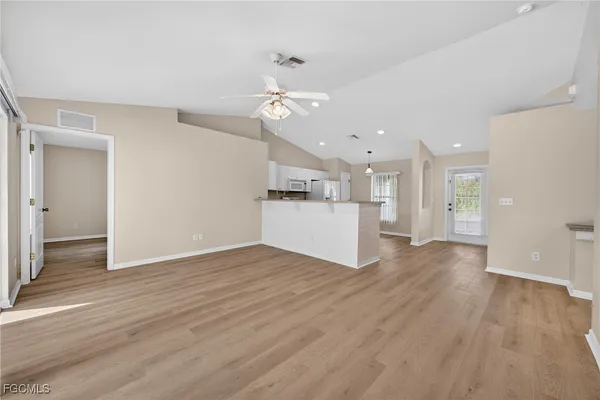 a view of a kitchen with a sink and a refrigerator