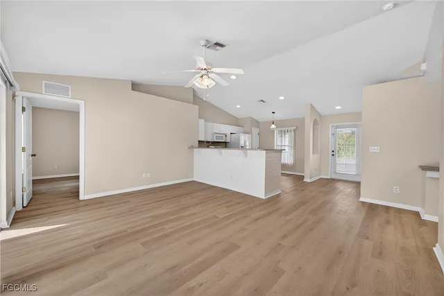 a view of a kitchen with a sink and a refrigerator