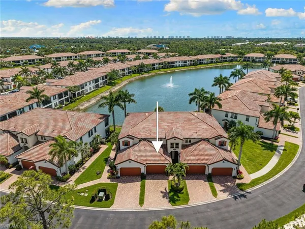 an aerial view of residential houses with outdoor space and river