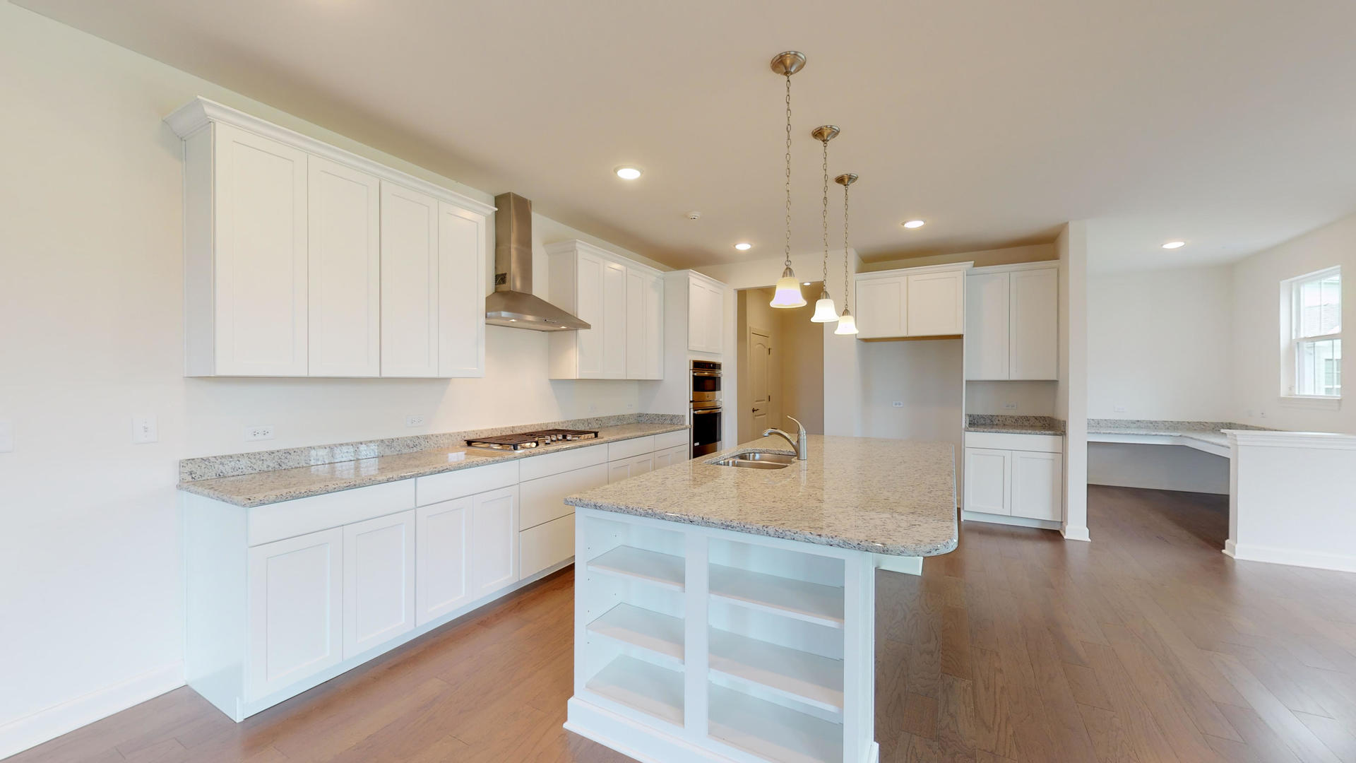 4335 Little Leaf Road Naperville, IL 60564 - Photo 6 of 13 a kitchen with stainless steel appliances granite countertop a stove a sink a refrigerator and white cabinets with wooden floor
