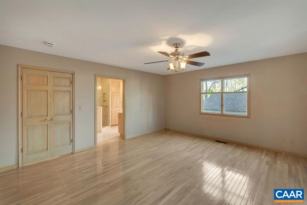 9 Out Of Bounds Road Palmyra, VA 22963 - Photo 19 of 37 a view of an empty room with a window and wooden floor